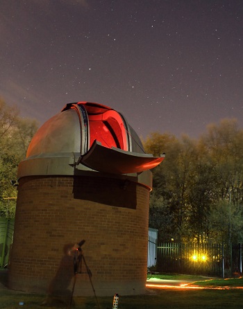 The Dome on Astrocampus at night with a photographer